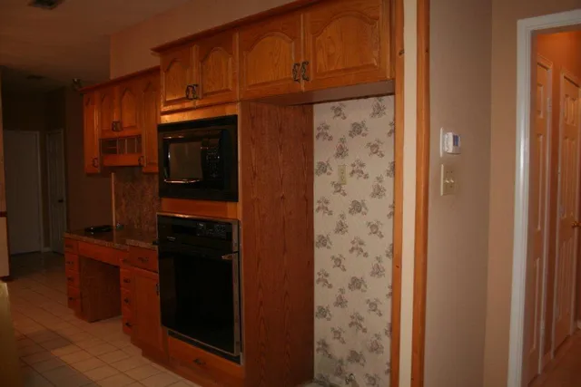 a kitchen with a refrigerator and cabinets