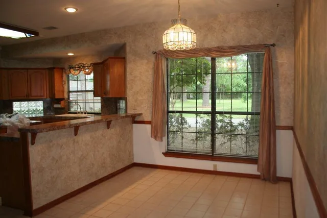 a view of kitchen with granite countertop cabinets and wooden floor