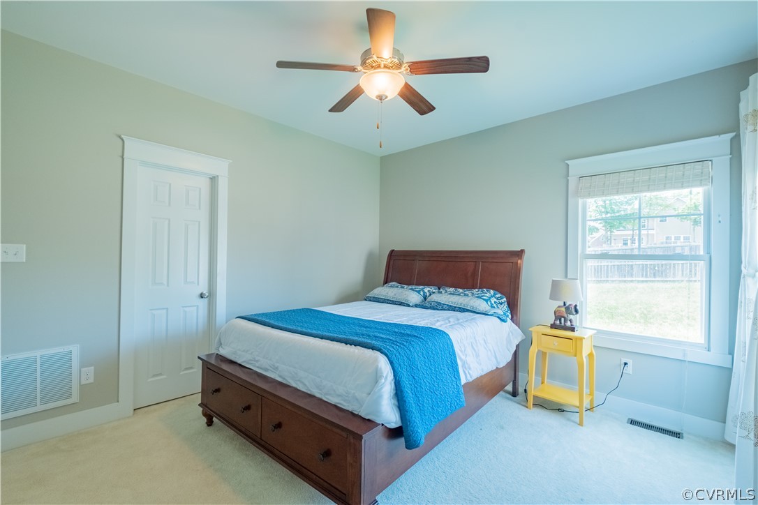 4935 Turner Ridge Court Glen Allen, VA 23059 - Photo 22 of 50 a bedroom with a bed and a chandelier
