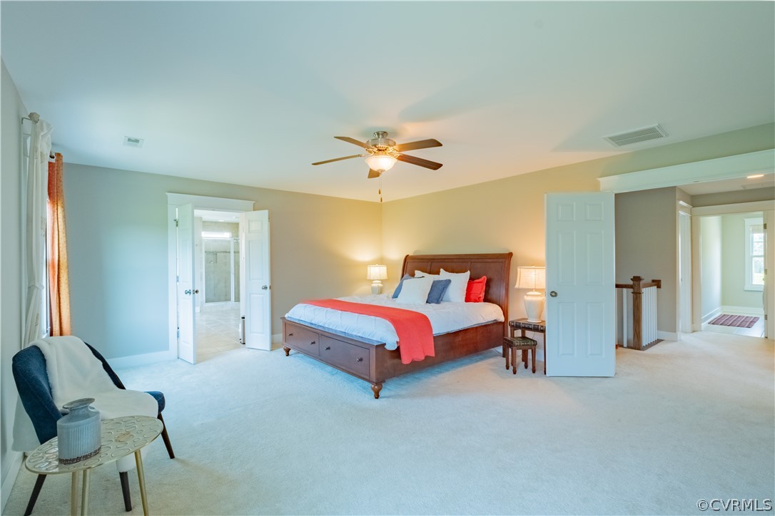 4935 Turner Ridge Court Glen Allen, VA 23059 - Photo 28 of 50 a spacious bedroom with a bed and a chandelier
