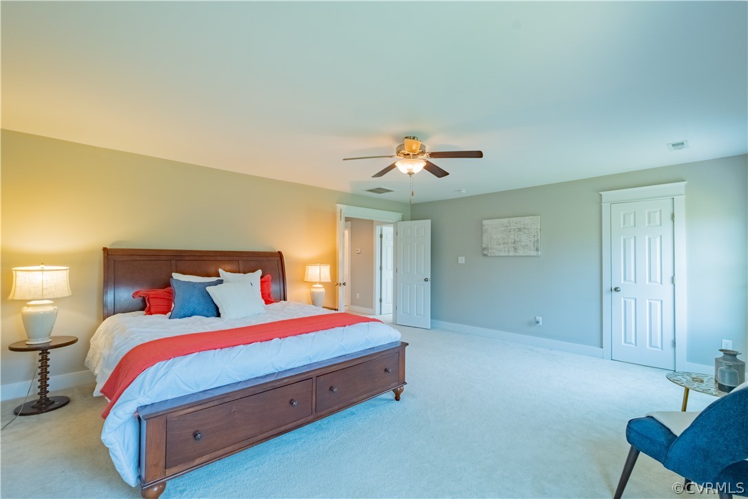 4935 Turner Ridge Court Glen Allen, VA 23059 - Photo 29 of 50 a bedroom with a bed and a chandelier