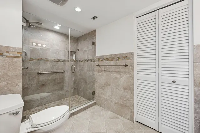 a bathroom with a shower a toilet and a sink