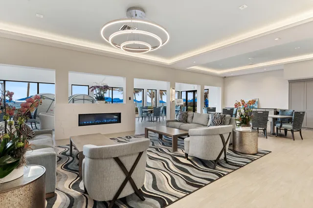 a view of a dining room with furniture and a chandelier