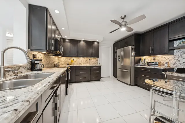a kitchen with stainless steel appliances a sink a stove and a refrigerator
