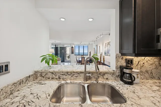 a kitchen with a sink and a stove top oven