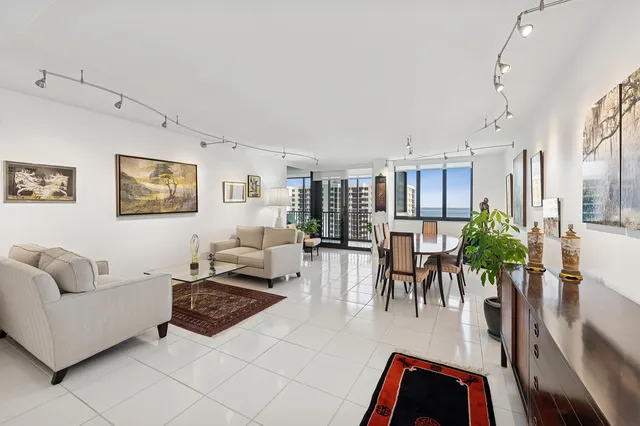 a living room with furniture potted plant and a large window
