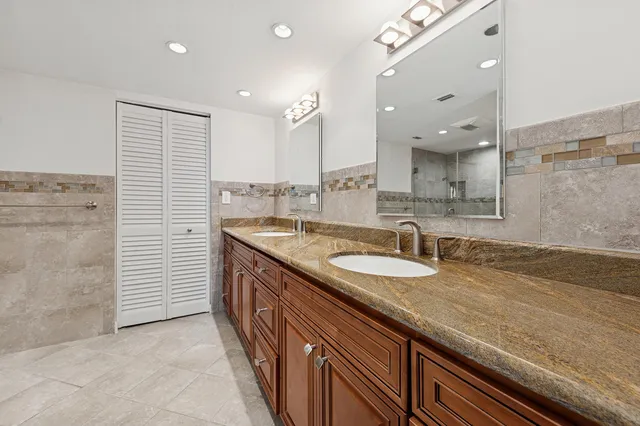 a bathroom with a sink double vanity and a shower
