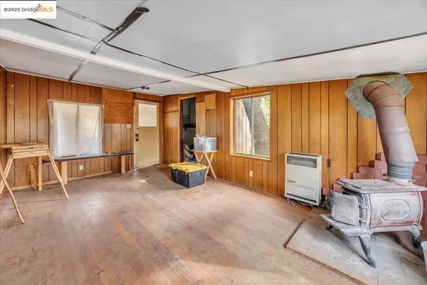 a bedroom with furniture and large windows