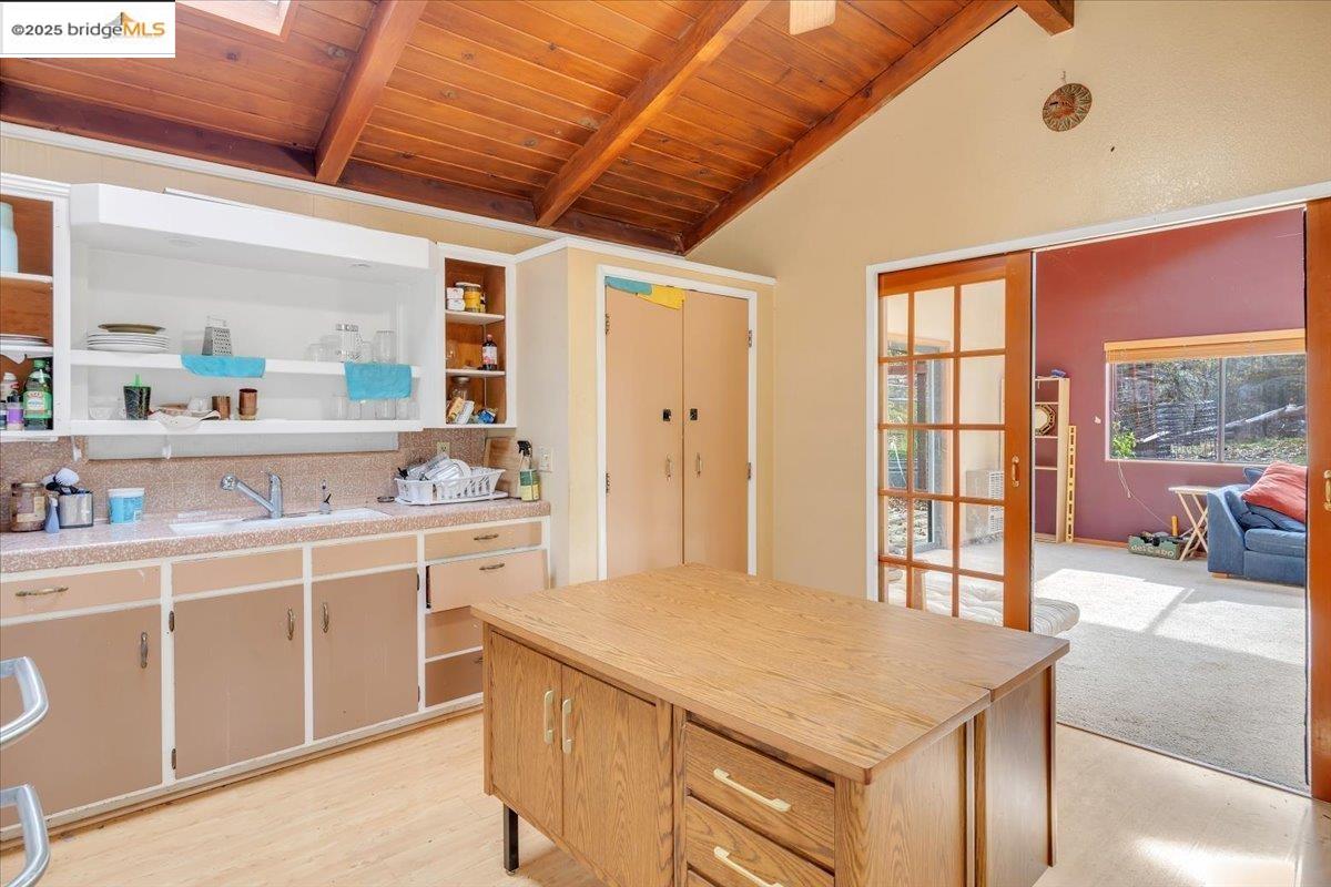 25300 Italian Bar Road Columbia, CA 95310 - Photo 39 of 60 a kitchen with a stove a sink dishwasher and white cabinets with wooden floor