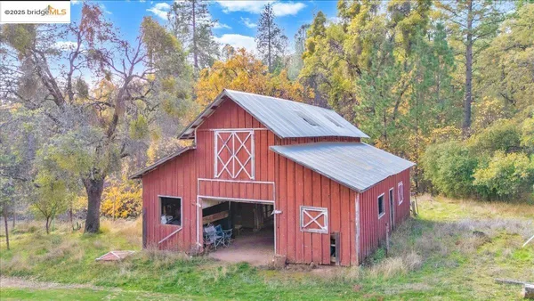 a view of house with backyard and seating space