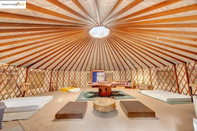 a bedroom with furniture and a large window