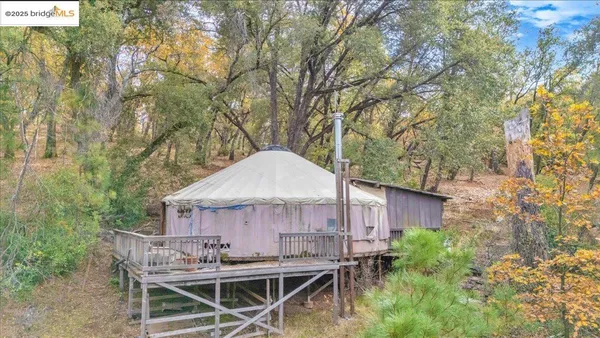 a view of a house with a wooden fence