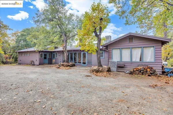 a view of a patio with a table and chairs and potted plants