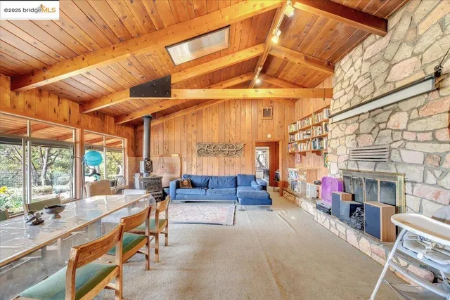 a bedroom with furniture and a large window