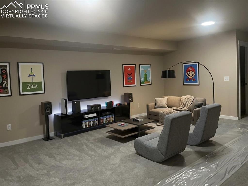 6684 Rawhide Rdg View Colorado Springs, CO 80915 - Photo 27 of 37 a living room with furniture and a flat screen tv