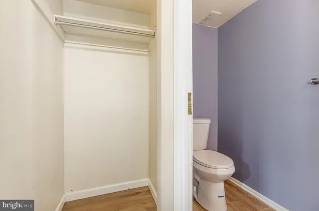 a white toilet sitting next to a shower