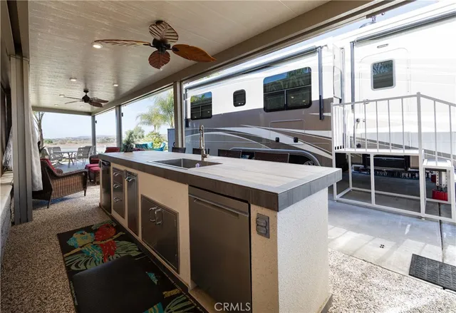 a living room with furniture a flat screen tv and a large window