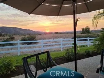a front view of a house with sitting area