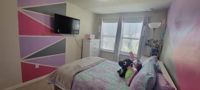 a bedroom with furniture and a window