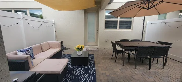 a view of a dining room with furniture and chandelier