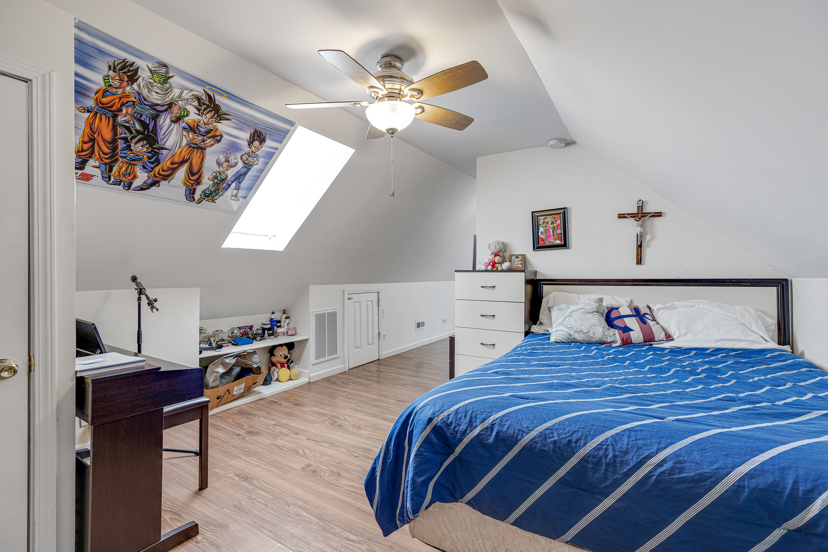 2135 North Menard Avenue, Unit 3 Chicago, IL 60639 - Photo 6 of 10 a bedroom with a large bed and a chandelier