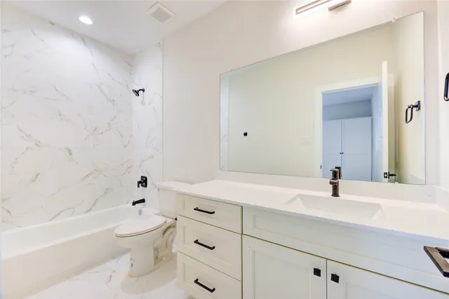 a bathroom with a sink a toilet and a bathtub