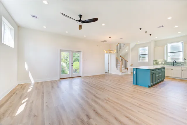 a large kitchen with hardwood floor a sink and a refrigerator