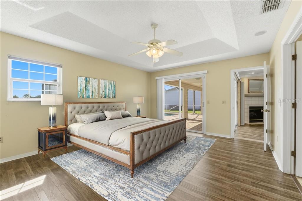 3650 Wildcat Run Lakeland, FL 33810 - Photo 18 of 59 a bedroom with a large bed a chandelier and windows