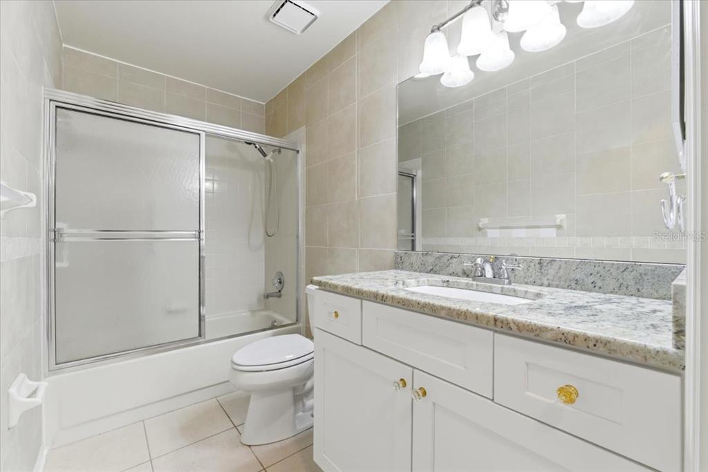 3650 Wildcat Run Lakeland, FL 33810 - Photo 29 of 59 a bathroom with a granite countertop sink toilet a mirror and shower