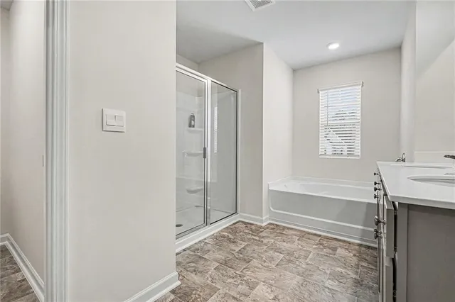 a bathroom with a tub shower and sink