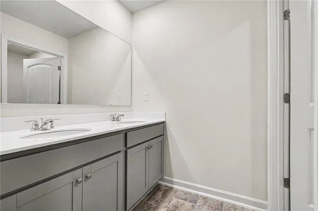 a bathroom with a double vanity sink and a mirror