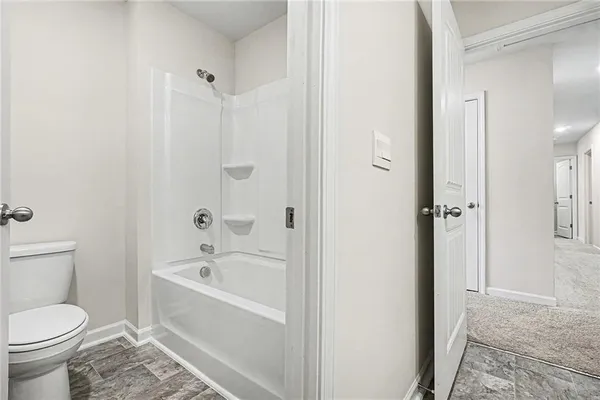 a bathroom with a bathtub and a toilet