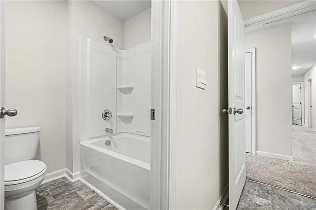 a bathroom with a bathtub and a toilet