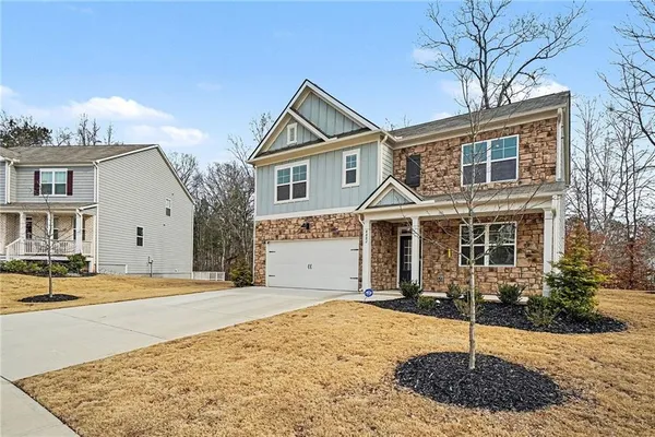 a front view of a house with a yard