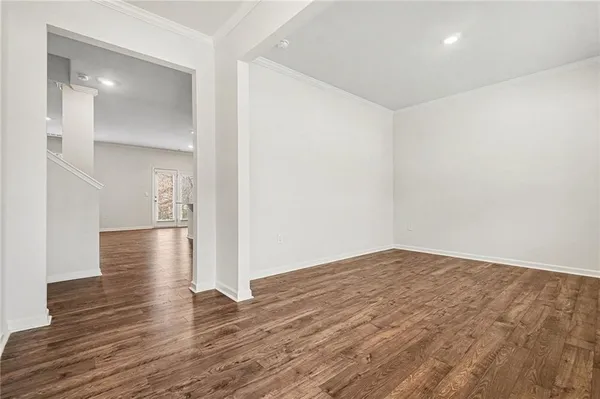 a view of a hallway with wooden floor