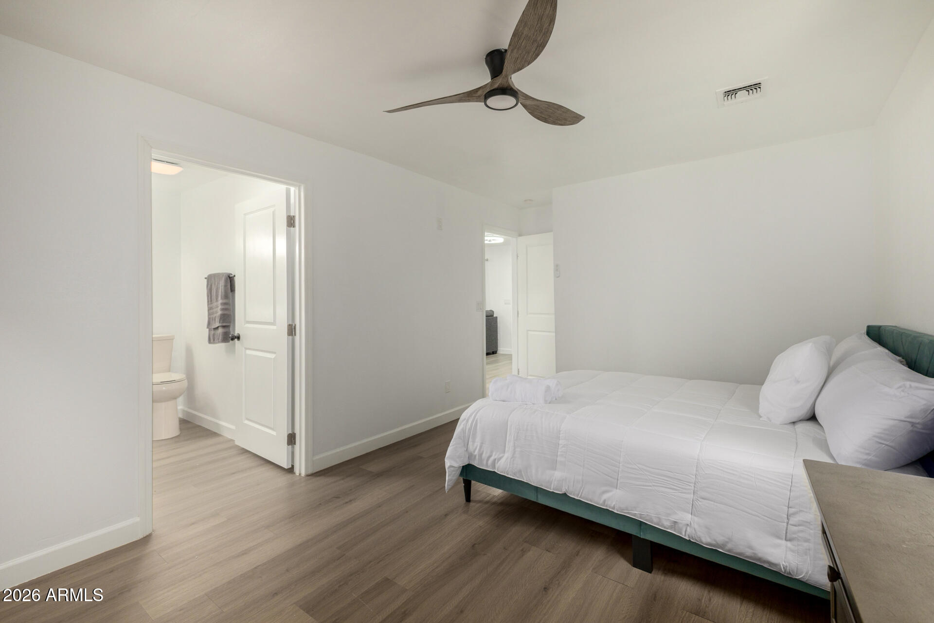 2142 West Coolidge Street Phoenix, AZ 85015 - Photo 15 of 28 a bedroom with a bed and a chandelier