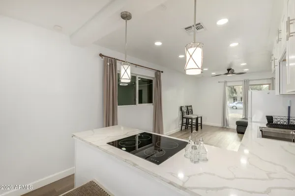 a kitchen with granite countertop a sink a counter and cabinets
