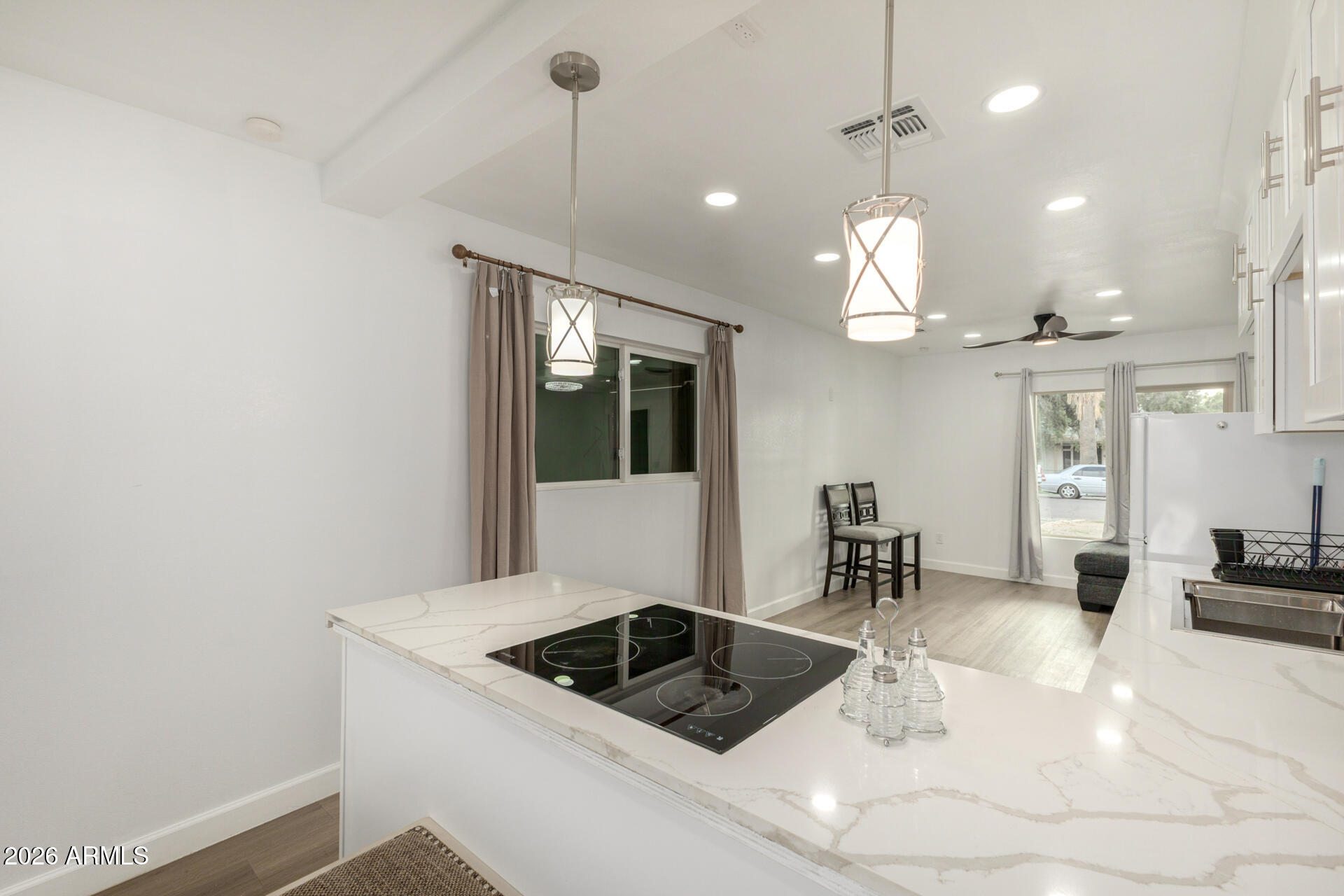 2142 West Coolidge Street Phoenix, AZ 85015 - Photo 18 of 28 a kitchen with granite countertop a sink a counter and cabinets