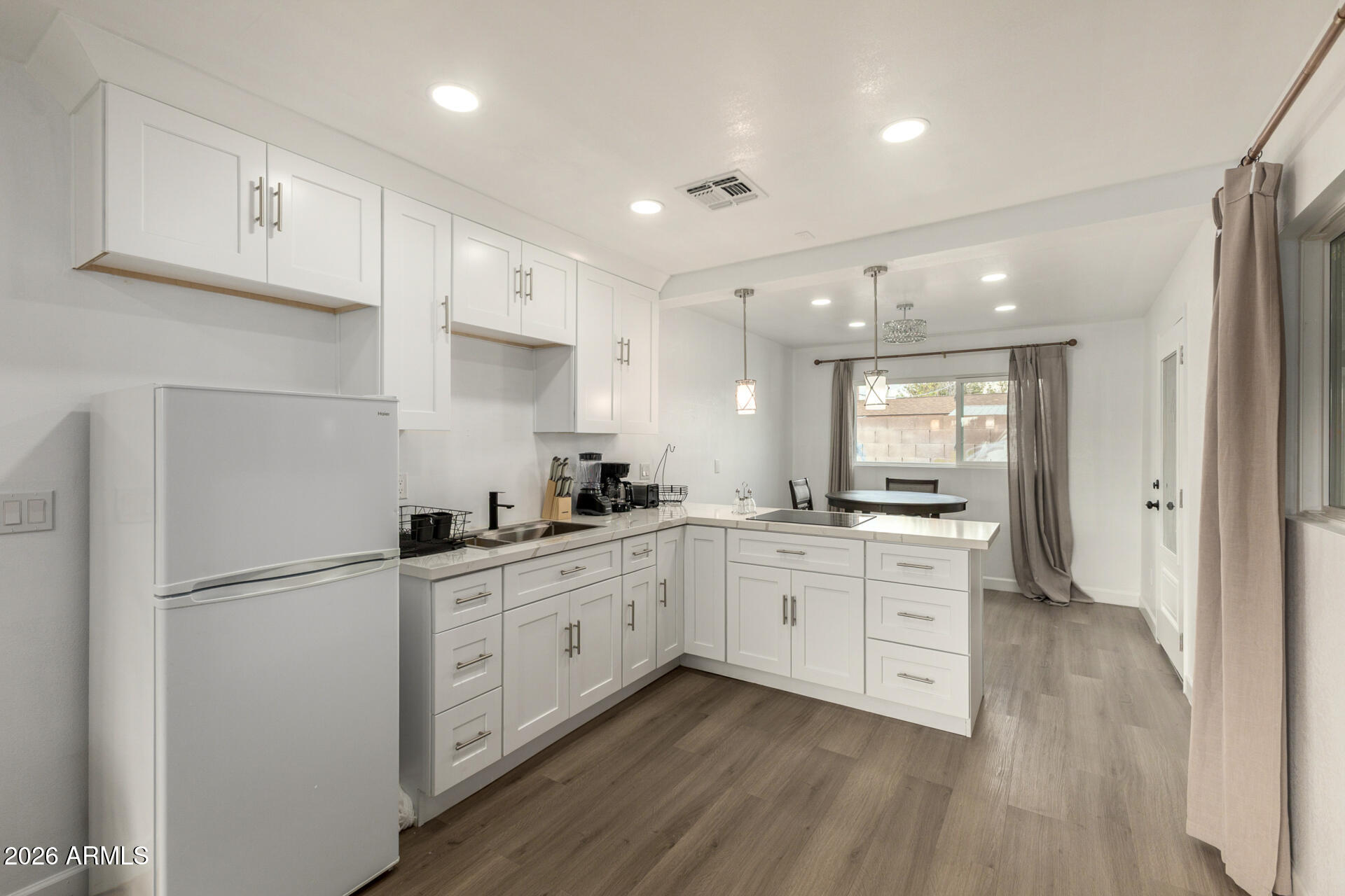 2142 West Coolidge Street Phoenix, AZ 85015 - Photo 22 of 28 a kitchen with white cabinets and sink