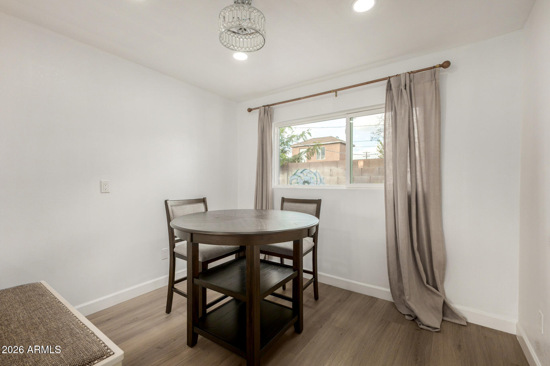 2142 West Coolidge Street Phoenix, AZ 85015 - Photo 23 of 28 a view of a dining room with furniture window and wooden floor