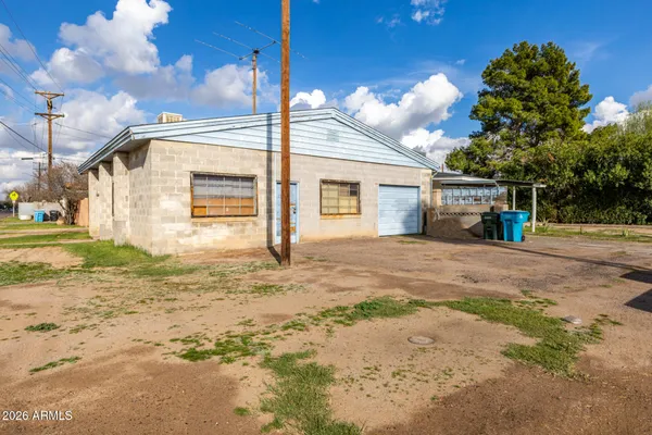 a view of a house with a backyard