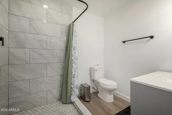 a white toilet sitting next to a bathroom sink