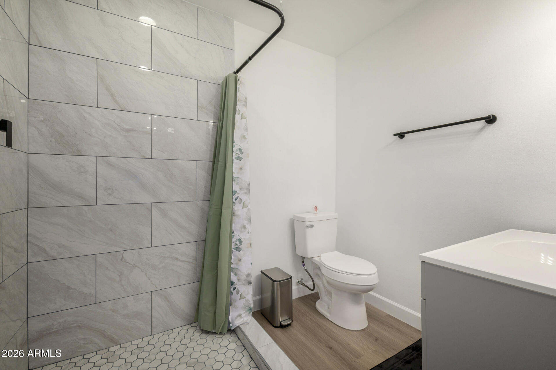2142 West Coolidge Street Phoenix, AZ 85015 - Photo 10 of 28 a white toilet sitting next to a bathroom sink