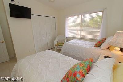 6650 Beach Resort Drive, Unit 908 Naples, FL 34114 - Photo 11 of 15 a bedroom with two beds and a flat screen tv