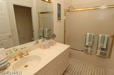 6650 Beach Resort Drive, Unit 908 Naples, FL 34114 - Photo 12 of 15 a bathroom with a sink and a mirror