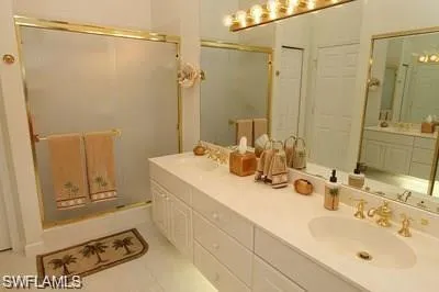 a bathroom with a sink mirror and shower