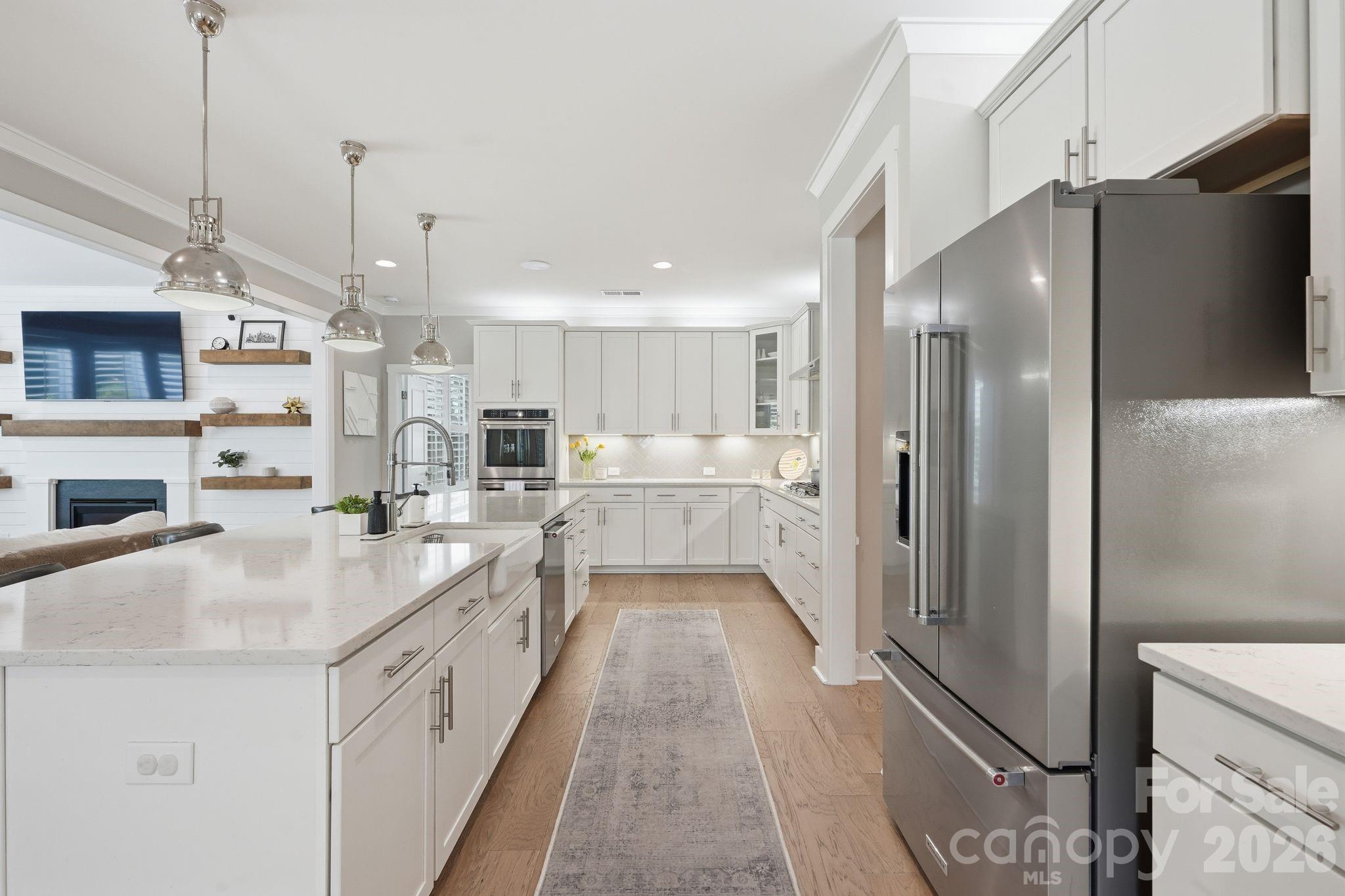 1086 Weir Court Fort Mill, SC 29708 - Photo 10 of 40 a large kitchen with stainless steel appliances kitchen island granite countertop a refrigerator and a sink