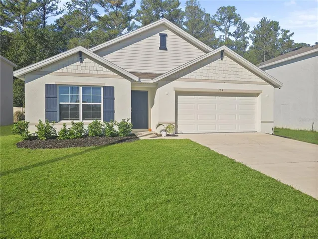 a view of a yard in front view of a house