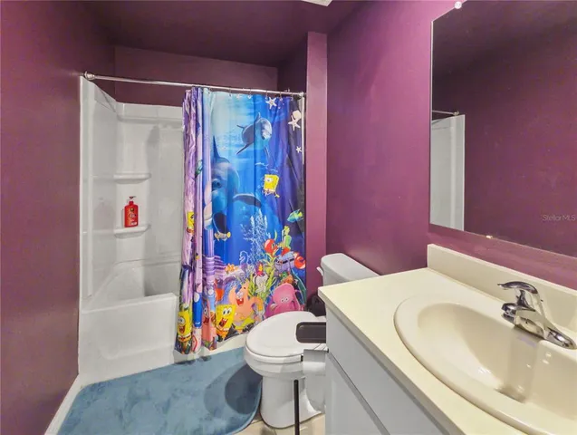 a view of an empty room and a bathroom