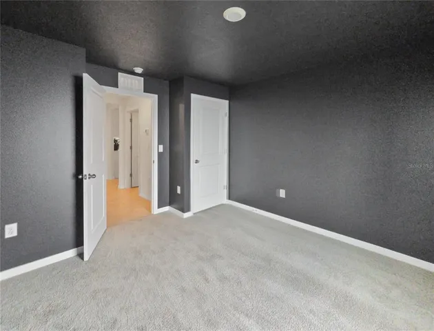 an empty room with a empty space and windows